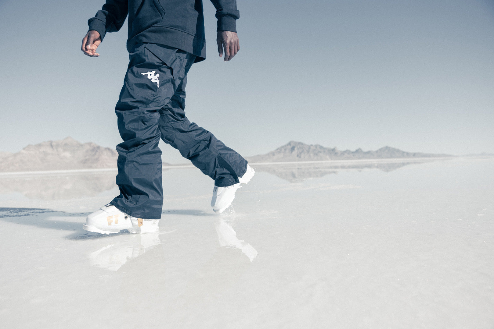 Close up shot of US ski athlete walking on ice in Kappa Ski and Snowboard Gear.